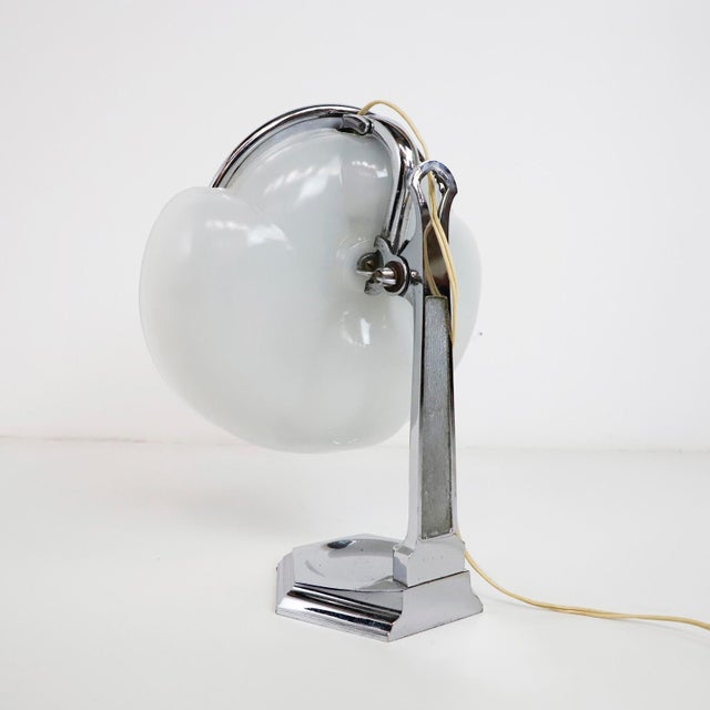 circa 1940. We offer this illuminated dresser top Art Deco vanity mirror. Beautiful supple modern line and curves. The...