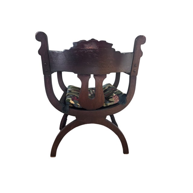 Renaissance Revival Savonarola-style carved wooden chair with a lion motif. Manufactured in the early 20th century using...