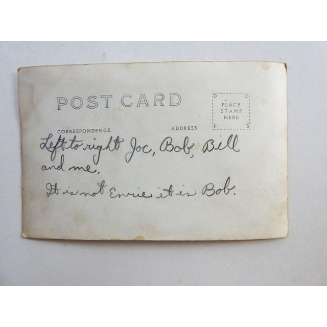 Early 20th century sepia tone real photo postcard (RPPC) photograph of a group of men in a studio set for a saloon....