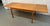 This Mid-century modern Danish teak dining table features two sliding draw-leaf extensions for versatile seating. Open...