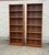 Impressive pair of vintage Mid-Century Modern bookcases with warm, richly grained wood veneers and clean architectural...