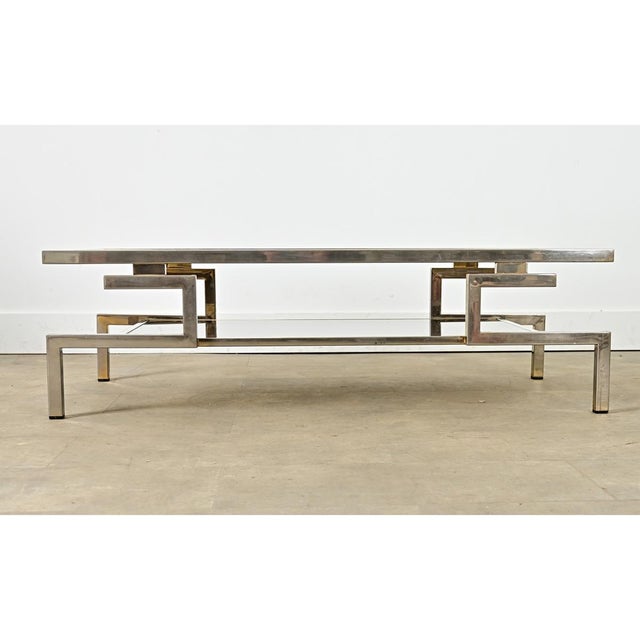 This sleek, rectangular coffee table was originally designed by Guy Lefèvre, part of a larger collection produced by the...