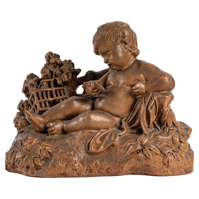 Terracotta representing a child and a bird in the hand, signed, early 20th century, louis xv style. Measures: h: 24 cm, w:...