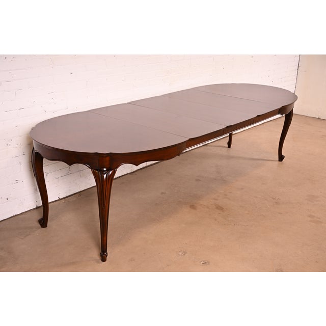 An exceptional French Provincial Louis XV style extension dining table In the manner of Baker Furniture By Weber Furniture...