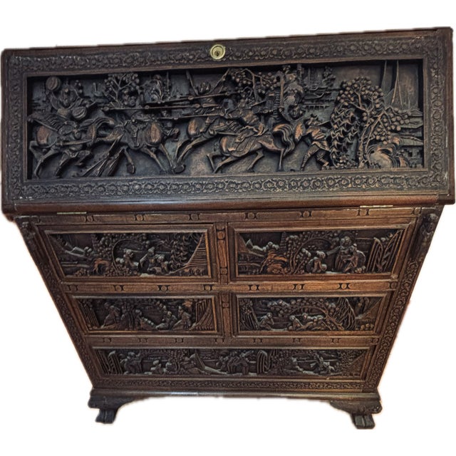 Beautifully hand carved walnut desk with battle and other scenes of Chinese life carved and three sides of the desk. Five...