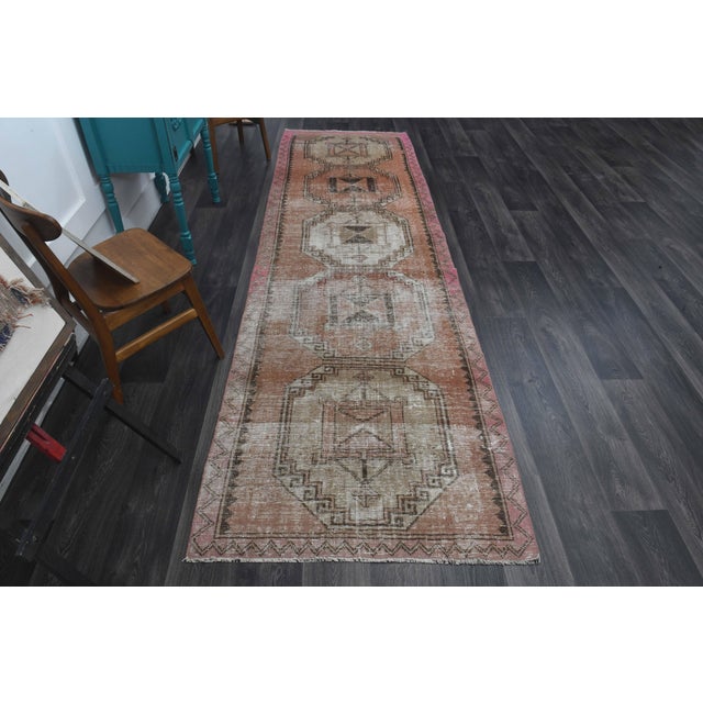 Vintage Hand-Knotted runner rug is a semi-antique vintage runner rug. The '70s Eastern region of Anatolia's unique rug is...