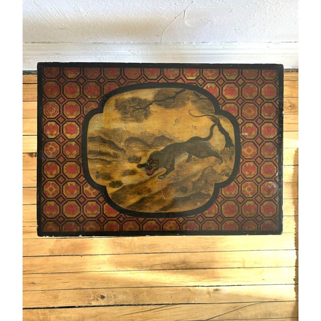 This gorgeous red, black, and gold lacquered low table or stool is a wonderful example of Chinoiserie. Intricately carved...