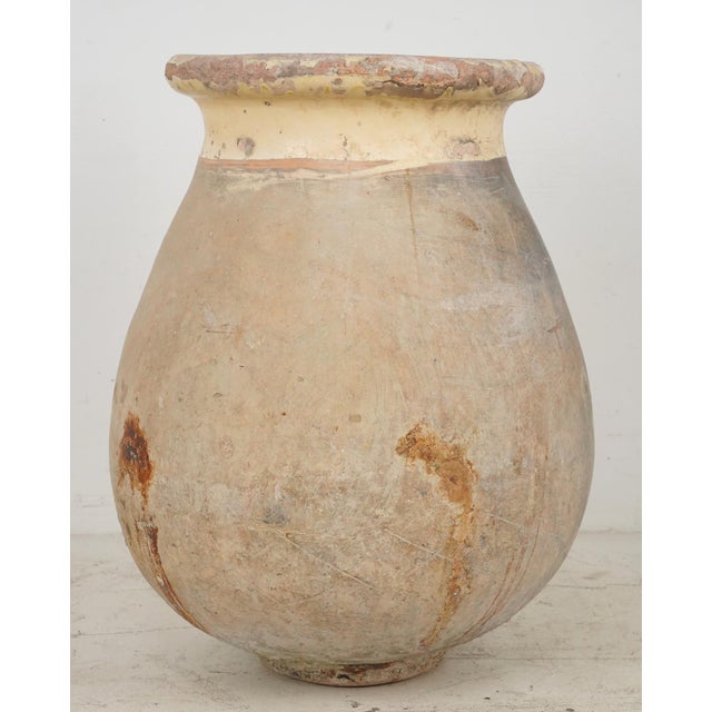 19th century olive jar made of blond terra cotta clay with a pale ochre glaze. It was made in Biot, Provence, France,...