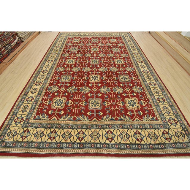 A traditional Kazak rug hand-knotted with fine wool on a cotton foundation. This oriental rug features a repeating pattern...