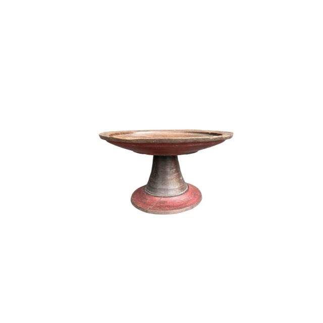 A vintage Balinese dulang tray combining exposed natural wood with remnants of original red pigment along the base. The...