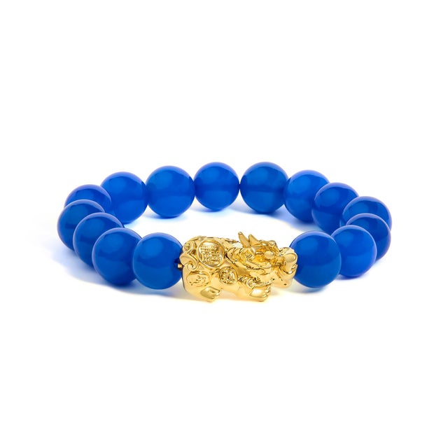 Saturated with oceanside blue and crowned with a guardian of luck, this beaded beauty marries talismanic charm with...