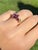 The Mattagami: Ladies 14K Garnet Three Stone Ring. Crafted in 14 karat yellow gold, this contemporary ring centers on a...