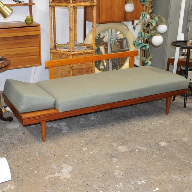 A sofa daybed by ingmar relling with a teak frame in upholstered pale green fabric. manufacturer – ekornes designer –...