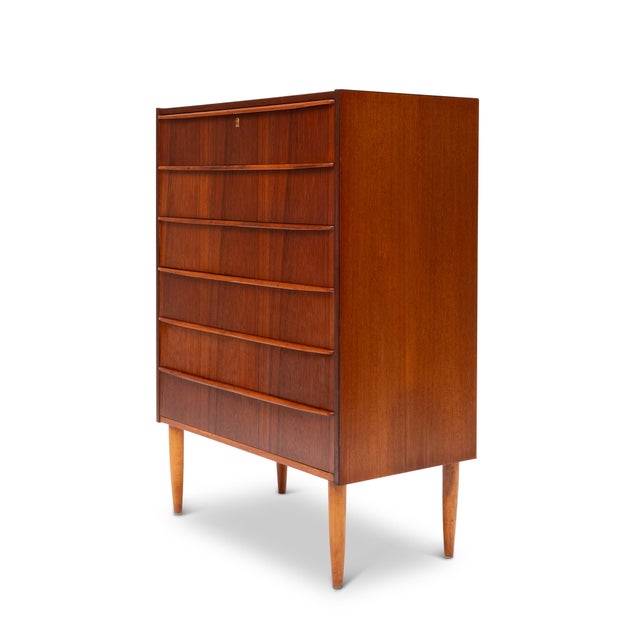 This stunning 1960s Danish Mid-Century teak tallboy dresser is a timeless piece of craftsmanship. Featuring exquisite wood...