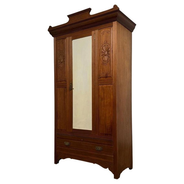 A handsome and beautifully proportioned early 20th-century Edwardian wardrobe, crafted in richly coloured walnut and...