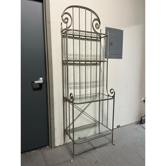 Great iron etagere in the manner of Claudio Rayes. Nicely proportioned 4 shelves with curved glass. Solid and sturdy.
