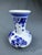 A stunning vintage Delft Blue bud vase, hand-painted in the classic Dutch tradition. The bulbous body features a windmill...