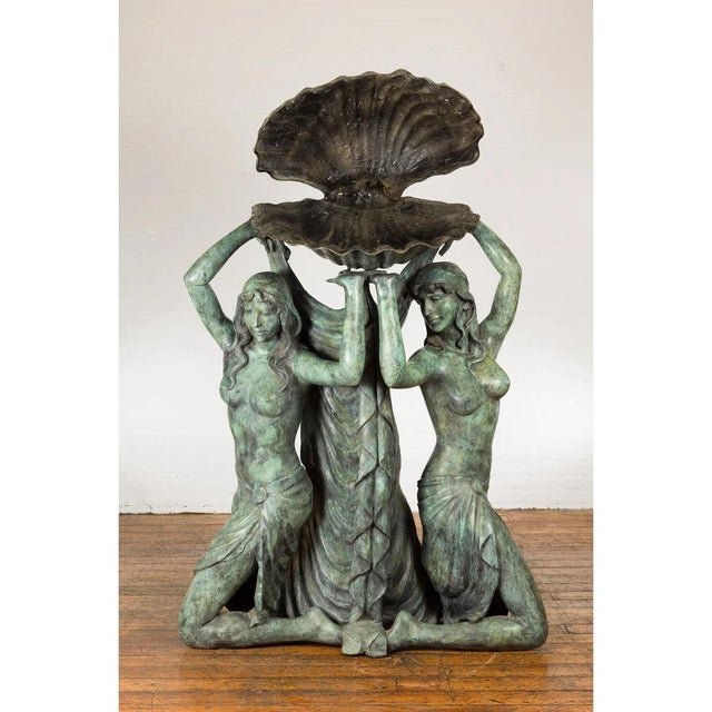 A Greco-Roman inspired lost wax cast bronze fountain depicting three nymphs holding a large shell above their heads. Delve...