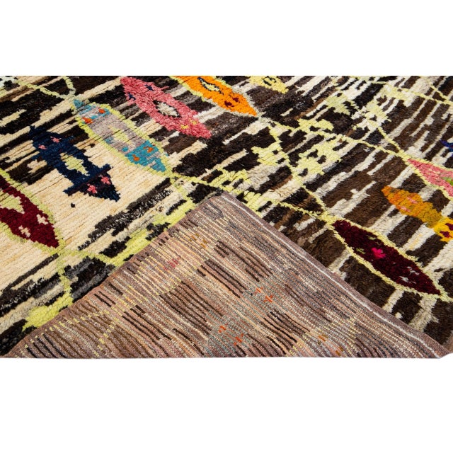 Beautiful Turkish Tulu handmade wool rug with a beige and brown field. This Modern rug has multicolor accents features a...