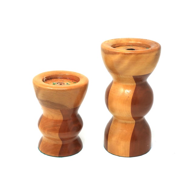 A set of two vintage handmade pillar candle holders, composed of layered, turned and lacquered wood. Good vintage...