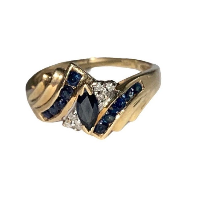 A lovely vintage 10k gold marquis cut blue sapphire and diamond cocktail ring. This is such a beautiful piece, it would...