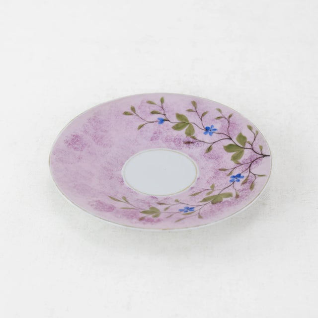 Delight in the charming simplicity of this vintage porcelain saucer, featuring a hand-painted design of lilac tones with...
