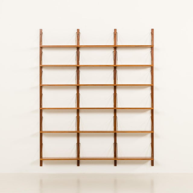 This Danish teak shelving unit is reminiscent of the iconic 1960s modular furniture designed by Poul Cadovius and was...