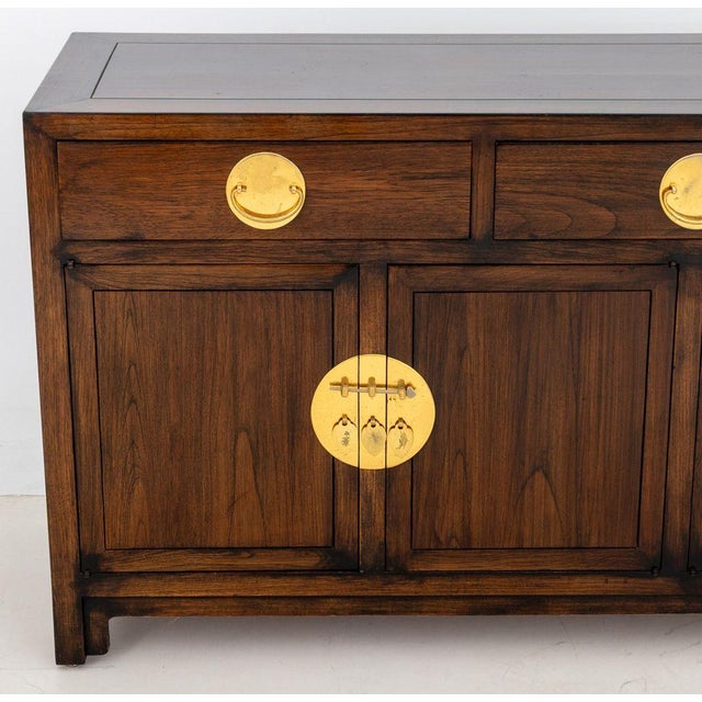 Asian Modern Brass Mounted Mahogany Sideboard, with three drawers above two double-door compartments opening to two...