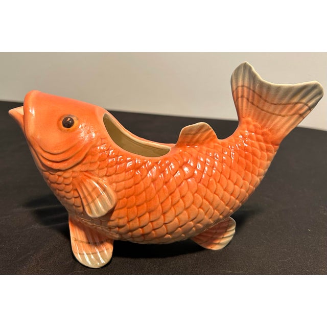 A striking vintage Fitz and Floyd ceramic planter featuring an elegant koi fish motif and beautifully sculptural form. The...