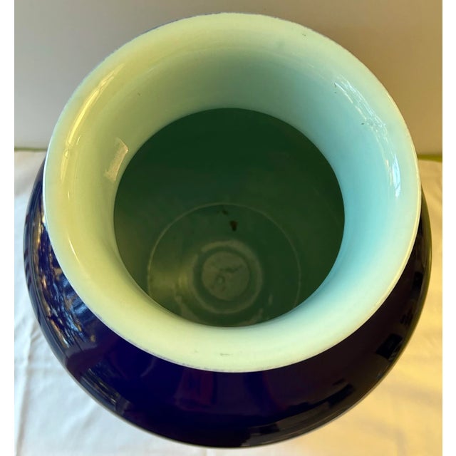 Large glazed porcelain “Monk Vase” by Middle Kingdom with a stunning indigo exterior and contrasting light blue interior....