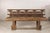 This antique Chinese wooden bench features a richly weathered surface and sculptural silhouette that give it a strong...
