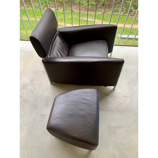 Very stylish armchair with ottoman. Some scratches, otherwise very good. This piece has an attribution mark, I am sure...