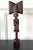 An expressively carved African wood female kneeling figure on staff with a display wood stand circa mid 20th century. The...