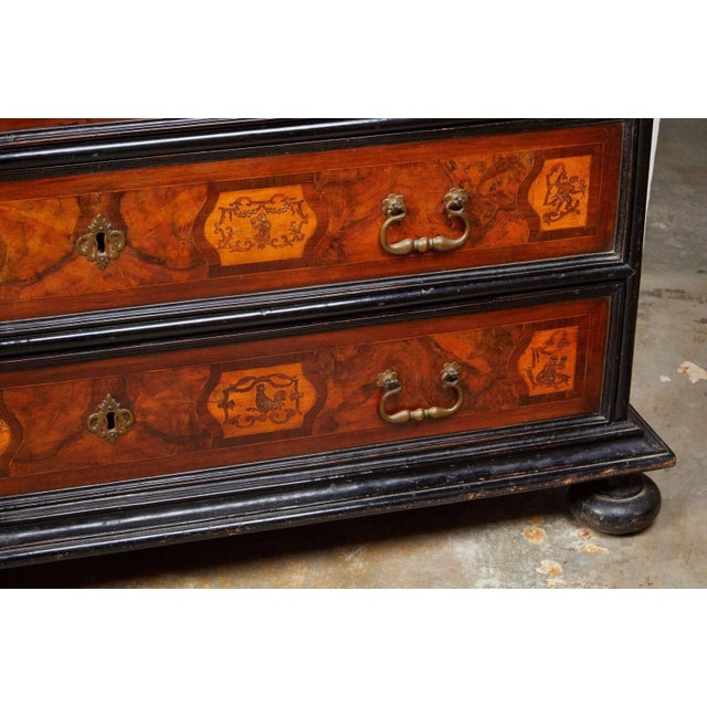 Fanciful yet handsome, 19th century, N. Italian, commode with three, paneled drawers atop bun feet. The whole is of walnut...