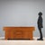 Sideboard with hinged doors and open drawers, designed by Michelucci in 1964, made of walnut veneer. This piece is...