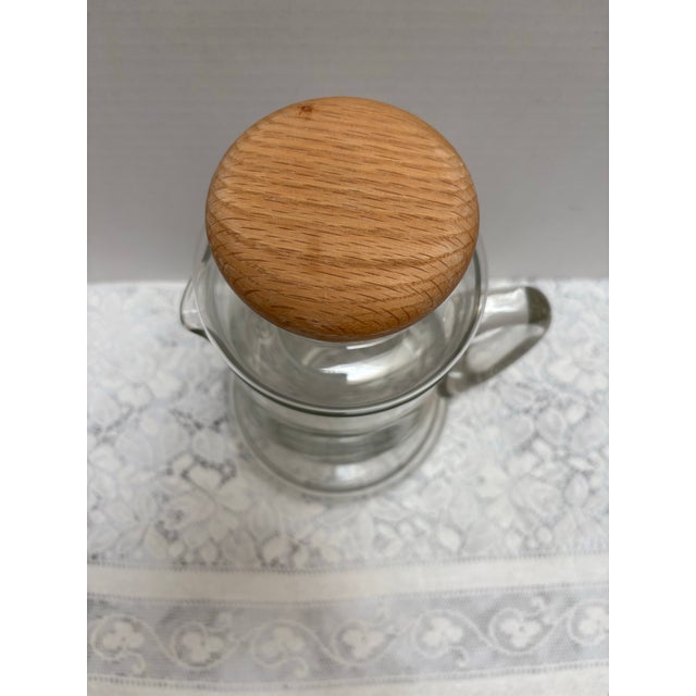 Vintage large glass, pitcher with wooden ball style top and interior glass chamber for ice. Unique and chic idea to keep...