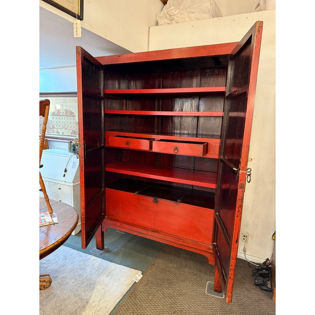 Design Plus Gallery presents a Antique Red Lacquered Chinese Cabinet. This extra large stunner has five shelves, two...