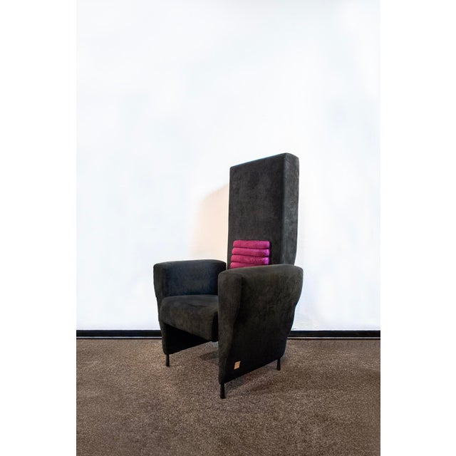 Armchair with wooden structure and padding covered in Alcantara. Flexible model Designer Ugo La Pietra Producer Busnelli...