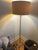 RH French Column Floor Lamp with an RH linen drum shade in sand. Based on a French original, the clear glass column is...