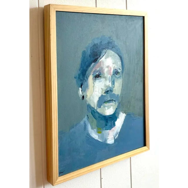 This portrait is painted in a muted palette of deep blues and whites, with rough, deliberate brushstrokes that leave the...