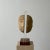 This hand-built ceramic sculpture is set on a lucite frame that’s attached to a solid cherry base. There is a crack on the...
