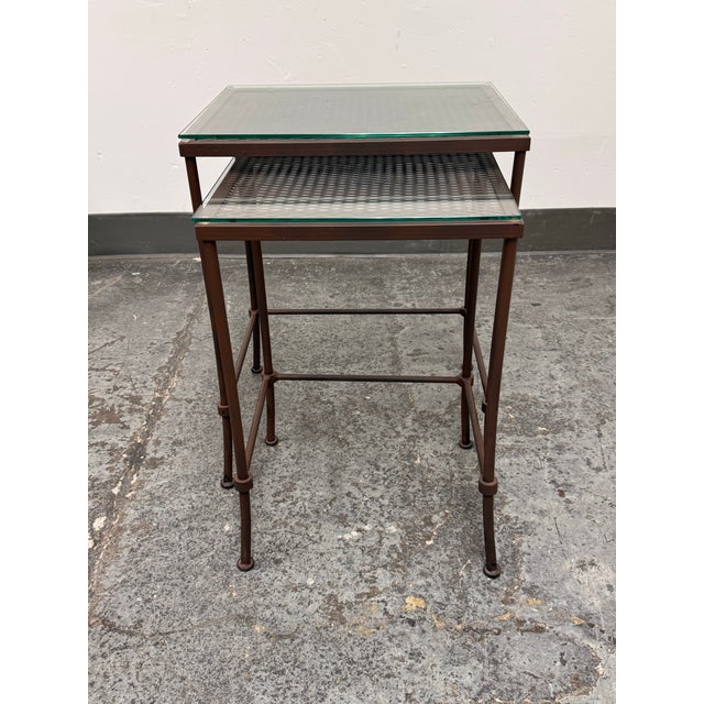 Design Plus Gallery presents a Set of Two Contemporary Glass Top Metal Nesting Tables. The tables have rectangular glass...