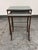 Design Plus Gallery presents a Set of Two Contemporary Glass Top Metal Nesting Tables. The tables have rectangular glass...