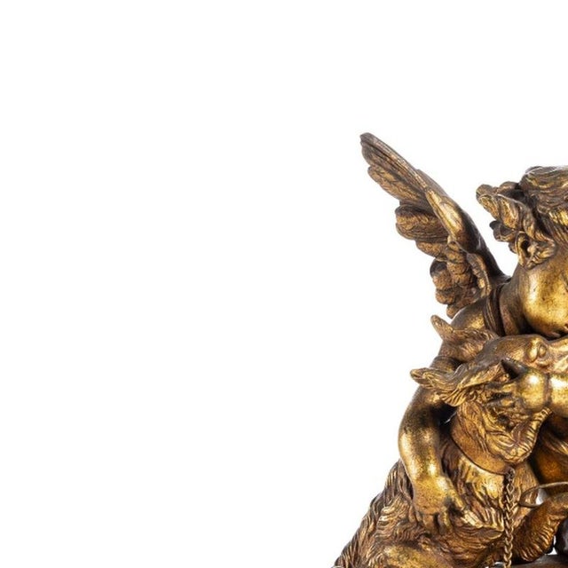 Table clock - 19th century. French; late 19th century in gilded bronze; neoclassical decoration with cupid, dog and...