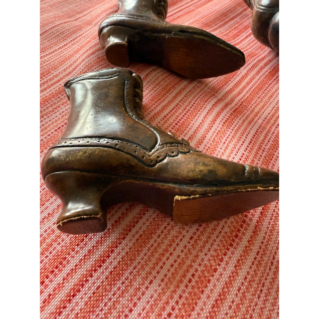 Two sets of Theodore Alexander bronze shoes or boots. Decorative bronze & leather (laces) shoes by Theodore Alexander,...