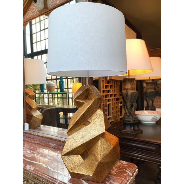 These Christopher Guy table lamps are hand-sculpted solid mahogany wood in a gold finish with chrome hardware. With their...