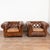 Pair of 20th century English Chesterfield club chairs upholstered in vintage brown leather. Traditional button tufted...