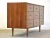 A mid century modern walnut nine drawer dresser by Mainline by Hooker with black and aluminum knobs. Professionally...