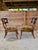 A stunning and highly stylish pair of Tommy Bahama rattan side slipper chairs featuring sculptural ring-back detailing and...