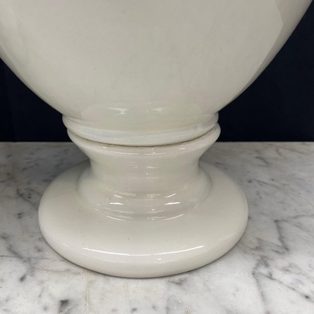 A pair of large Italian white ceramic urn vases with lovely round lids and fruit garlands on the sides. Seven point crown...